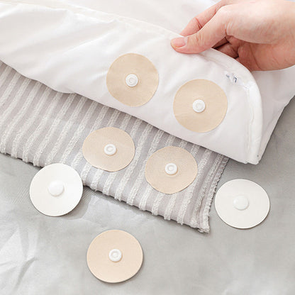 Återanvändbara halkfria knappar för att hålla täcket på plats
